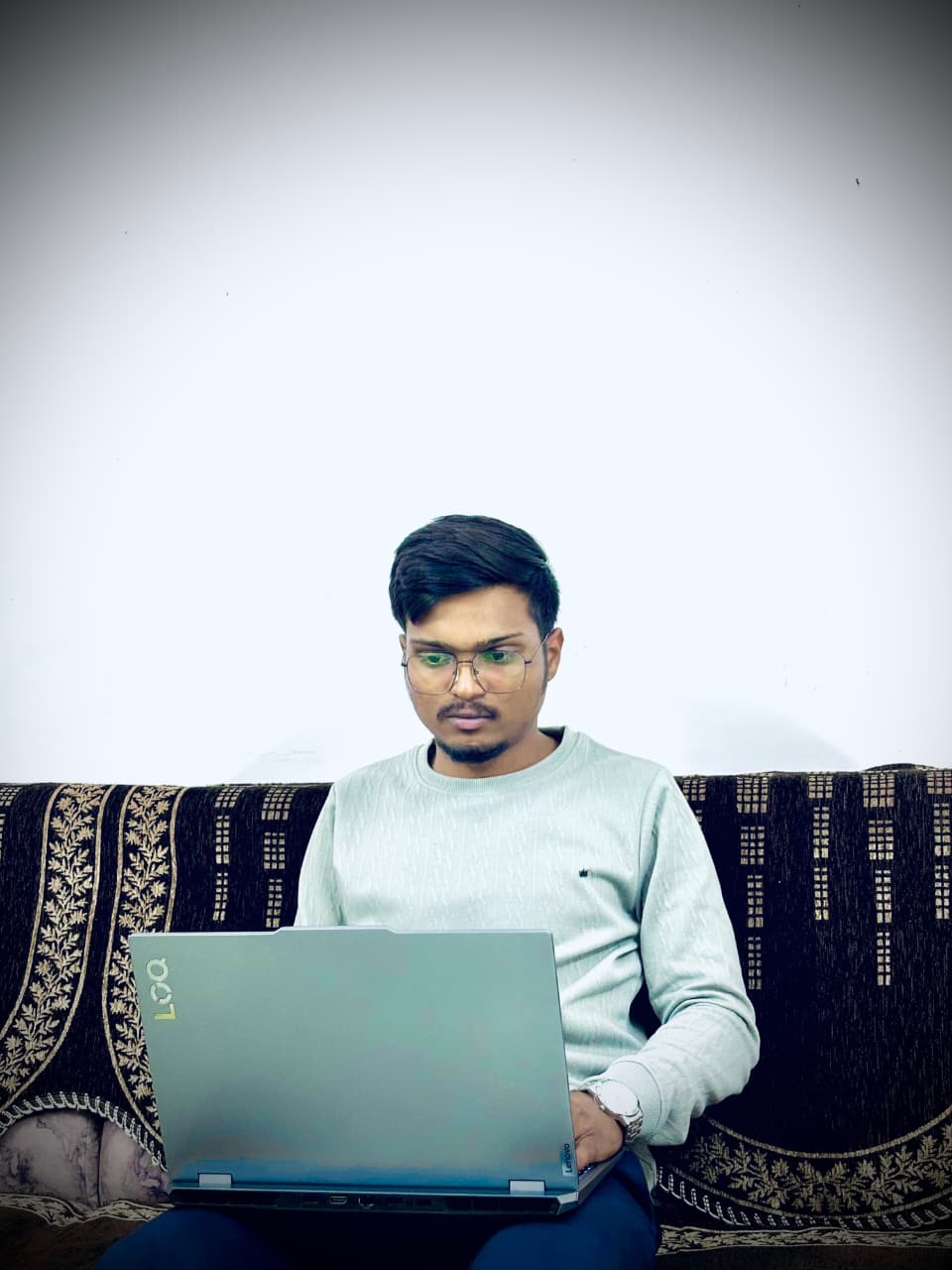 Jayendrasinh working on his laptop